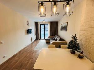 a living room with a christmas tree on a table at Best apartment in Orbi Palace in Itʼkhvisi +5 photos
