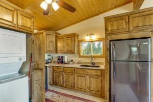 een keuken met houten kasten en een koelkast bij Ozarks Waterfront Home with Dock and Marina Access in Warsaw