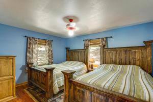 twee bedden in een slaapkamer met blauwe muren bij Ozarks Waterfront Home with Dock and Marina Access in Warsaw