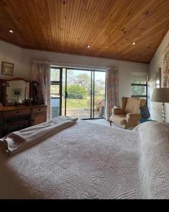 a large bedroom with a large bed and a couch at Stone Trading Pty Ltd in Durban