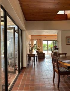 a living room with a table and chairs and sliding glass doors at Stone Trading Pty Ltd in Durban +5 photos