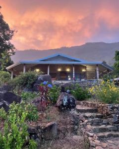 a house with a garden in front of it at Blackwoods Farmhouse in Beragala