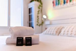 a pile of towels sitting on top of a bed at Appartement Le perchoir - Welkeys in La Guillotière