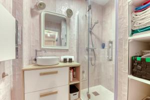 a bathroom with a sink and a shower at Appartement Le perchoir - Welkeys in La Guillotière