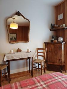 a room with a table and chairs and a mirror at B&B Marcellina in Bard +29 photos