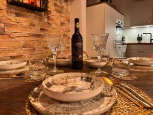 a table with plates and glasses and a bottle of wine at Stall & Glut - Landhaus mit Sauna & Kaminofen in Bad Zwischenahn +47 photos