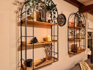 a room with wooden shelves on the wall at Stall & Glut - Landhaus mit Sauna & Kaminofen in Bad Zwischenahn