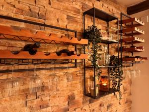 a brick wall with shelves and plants on it at Stall & Glut - Landhaus mit Sauna & Kaminofen in Bad Zwischenahn