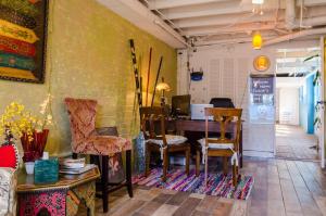 a room with a table and chairs and a wall at Madame Isabelle's House in New Orleans
