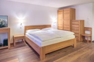 a bedroom with a large bed and wooden furniture at City Peak 2 Studio - in the heart of Zermatt in Zermatt