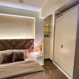 a bedroom with a large bed with a large mirror at Cozy & Comfy 1BHK in Sector 46 in Noida