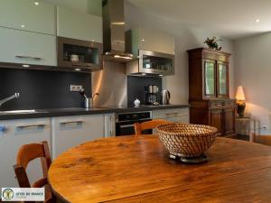 a kitchen with a wooden table with a bowl on it at Gite du Landas in Quins