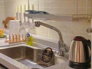 a kitchen sink with a dish drying rack above it at Busan Station KTX 1 minute distance single-family house, emotional interior, large flat, central location in Busan +81 photos