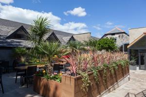 a patio with plants and a wooden fence at The White Hart Hotel Wetherspoon in Okehampton