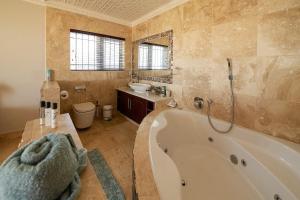 Un baño con bañera, lavabo e inodoro. en Jeffreys Bay Beach Accommodation Waters Edge, en Jeffreys Bay 13 fotos más