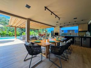 an open kitchen and dining room with a table and chairs at Casa Kuará Praia do Forte in Praia do Forte