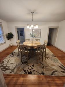 a dining room with a table and chairs on a rug at Cozy Albemarle 1 BR- EV charging in Albemarle