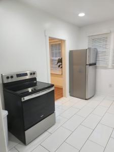 a kitchen with a stove and a refrigerator at Cozy Albemarle 1 BR- EV charging in Albemarle