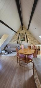 a dining room with a wooden table and chairs at La Bergerie d'Espiaube in Saint-Lary-Soulan