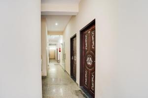 a corridor of a building with wooden doors at Hotel O Starlight Stay Jaipur International Airport in Jaipur