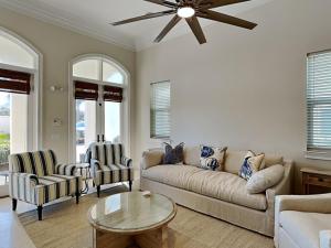 a living room with a couch and a table and chairs at Blue Mountain Bella in Blue Mountain Beach
