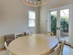 a white dining room with a table and chairs at Blue Mountain Bella in Blue Mountain Beach