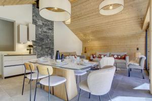 eine Küche und ein Esszimmer mit Tisch und Stühlen in der Unterkunft Escapade luxueuse avec jacuzzi et sauna au cœur du domaine des Portes du Soleil in Montriond