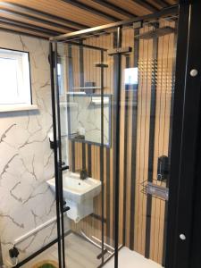 a bathroom with a sink and a mirror at Drive inn Room&Shower in Rīga
