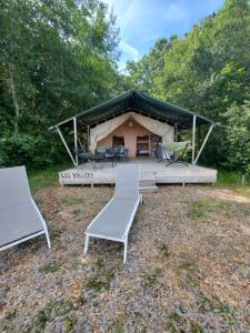 two chairs and a tent in a field at Les Cabanes de Rouffignac in Rouffignac Saint-Cernin +28 photos