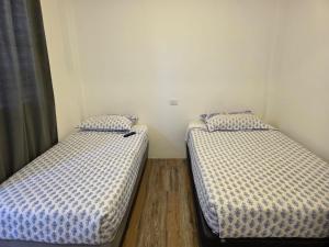 Postel nebo postele na pokoji v ubytování Hostal nancy