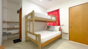 a small bedroom with a bunk bed in it at Habitacion Manglares 101 in Coveñas