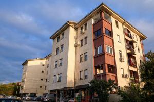 a tall building with cars parked in front of it at Sunset in Kriva Palanka