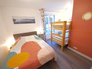 ein Schlafzimmer mit einem Bett und einem Etagenbett in der Unterkunft Résidence Brise de Mer - 1 in Port Nayalo