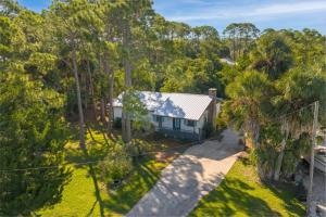 an aerial view of a house with trees at Cedar Key Seaside Escape in Cedar Key