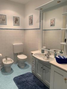 a bathroom with a toilet and a sink and a mirror at La casa di nonna Rosmi in Saluzzo +56 photos