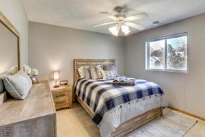 a bedroom with a bed and a ceiling fan at Across from Tetonka Lake 4-Season Getaway! in Waterville
