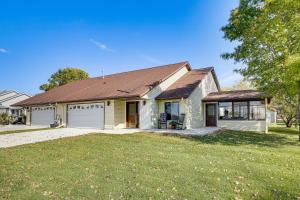 a white house with a brown roof at Across from Tetonka Lake 4-Season Getaway! in Waterville