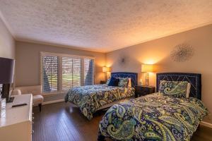 a bedroom with two beds and a window at Lakeside Living at Hound Ears in Valle Crucis