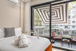 a bedroom with a bed and a large window at The Nest Residence by GoodMove - Gauthier Casablanca in Casablanca