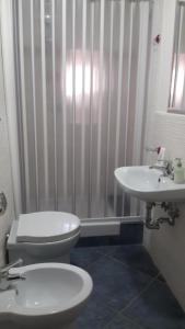 a bathroom with a toilet and a sink at B&B Villa San Nicola in San Nicola Arcella