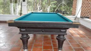 a pool table sitting on top of a brick floor at Finca Campestre Foundation Ecopiensa Evolution in Andalucía