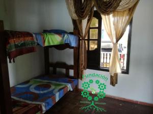 a room with two bunk beds and a window at Finca Campestre Foundation Ecopiensa Evolution in Andalucía