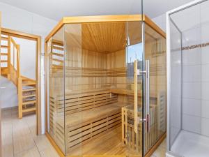 a sauna with wooden walls and a glass door at Windflüchter XL in Boiensdorf +37 photos