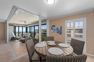 a dining room with a wooden table and chairs at Kings Crown 309 in Sanibel