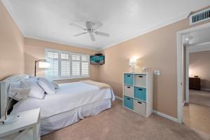 a bedroom with a bed and a ceiling fan at Kings Crown 309 in Sanibel +58 photos