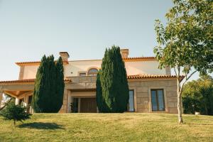 a house with two trees in front of it at Royal Fraga do Douro in Vila Real