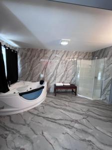 a bathroom with a sink and a bath tub at Chaplin Inn & Suites in Chaplin