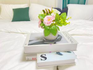 a box with a vase on top of a book at 달빛그리기Moonlight in Daegu
