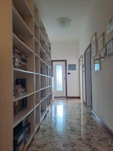 a room with bookshelves and a hallway with a door at B&B Sabry in Casalecchio di Reno