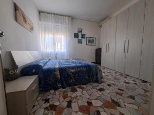 a bedroom with a bed with a blue comforter at B&B Sabry in Casalecchio di Reno